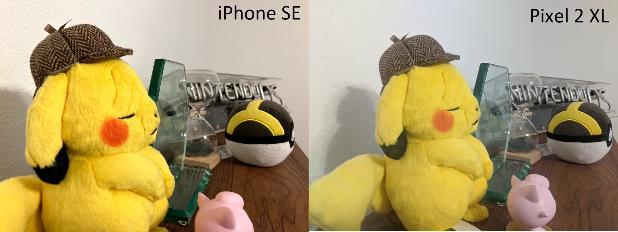 Side by side iPhone SE vs Pixel 2 XL pictures of Pikachu, pokeball, and neon sign on wood